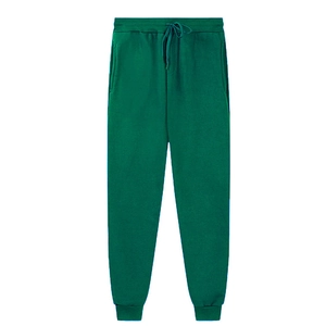 Flat lay of dark green fleece jogger pants with drawstring waist and ribbed ankle cuffs