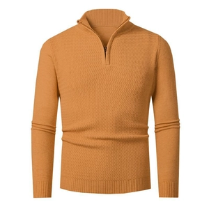Detailed view of ginger yellow quarter-zip sweater with unique wave knit texture patterns