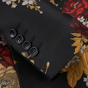 Close-up of slim fit floral blazer sleeve with red embroidery and four black buttons