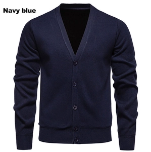 Close-up of navy blue men's knitted cardigan showing V-neckline and ribbed cuffs details