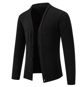 Detail of black men's knit cardigan with V-neck, button closure, and ribbed cuffs