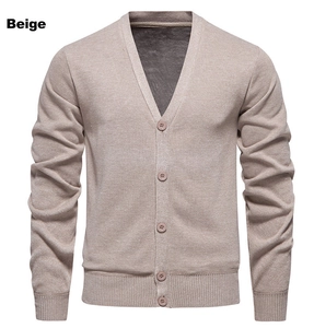 Close-up of beige men's V-neck cardigan showing ribbed cuffs and knit texture