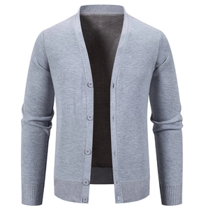 Close-up of fine knit texture and ribbed cuffs on men's gray V-neck cardigan
