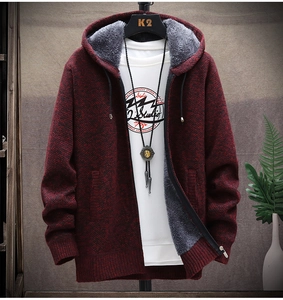 Close-up of men's burgundy cable-knit cardigan with warm grey fleece lining detail