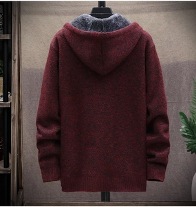 Detail view of a men's knit hoodie with red and black texture and fleece lining on back