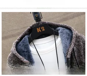 Detail view of the warm gray faux shearling lining and knitted texture of the hooded cardigan