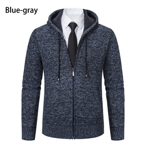 Detail of blue-gray knitted hoodie with soft fleece lining and zipper closure
