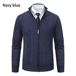 Detail of navy blue men's zip-up cardigan with vertical diamond knit texture and ribbed cuffs