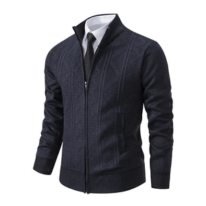 Detail of navy blue cardigan showing vertical cable knit texture and stand collar zipper