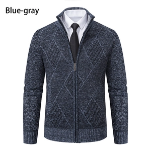 Detail of blue-gray knit cardigan featuring diamond texture and metal zipper closure