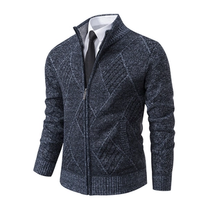 Detail of navy blue and grey argyle knit cardigan with standing collar and rib cuffs