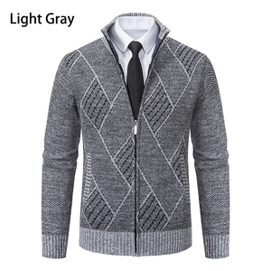 Detail of light gray knit cardigan featuring geometric texture and ribbed cuffs