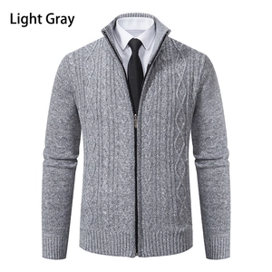 Macro detail of men's light gray cable knit sweater jacket with full zipper and stand collar