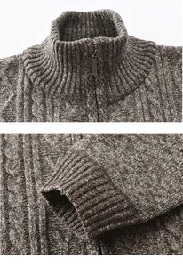Detail of men's brown cable-knit cardigan showing high neck zipper and ribbed cuffs