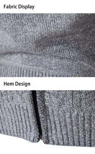 Detail of grey cable knit fabric texture and ribbed hem design on men's cardigan jacket