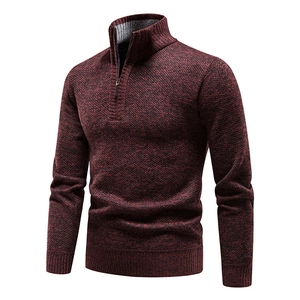 Detail of burgundy half-zip knit sweater with textured fleece lining and ribbed cuffs