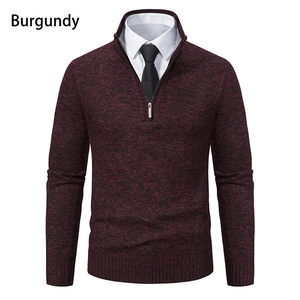 Detailed close-up of burgundy half-zip knit sweater with ribbed collar and texture