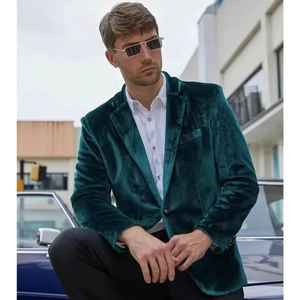 Detailed view of luxury dark green velvet blazer with slim fit cut and single button closure