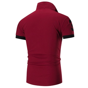 Detailed macro view of the burgundy polo shirt with black trim and sleeve number print