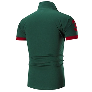 Detail of dark green polo shirt featuring a red contrast cuff and embroidered number 3 patch