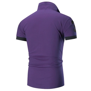 Macro detail of the back view of purple polo shirt with number three embroidery on sleeve