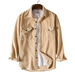 Detail view of khaki corduroy shirt with dual chest pockets and textured fabric