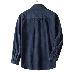 Detail view of navy blue corduroy shirt back with yoke and buttoned cuffs