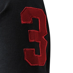 Close-up of premium dark red number 3 embroidery on black polo shirt sleeve detail