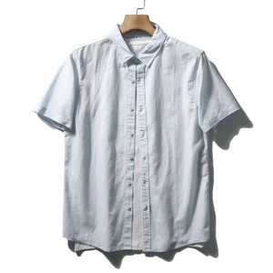 Men's light blue short sleeve shirt in breathable textured cotton hanging on hanger
