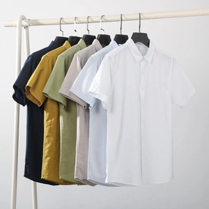 Men's minimalist cotton linen short sleeve shirts in various colors on a white rack