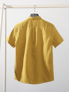 Mustard yellow men's short sleeve linen shirt with classic lapel and pleated back detail