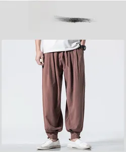 Detailed macro view of the drawstring elastic waist on red linen harem trousers