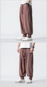 Detail view of linen blend harem pants featuring Chinese knot buttons on the cuffs