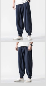 Detail of navy linen harem pants showing drawstring waist and natural fabric texture