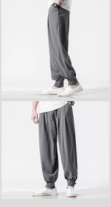 Detailed view of dark grey linen harem pants with traditional frog button cuff accents