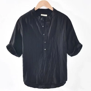 Detail of black linen t-shirt with mandarin collar and five-button placket on a hanger