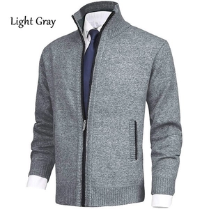 Macro detail of men's light gray thick knit cardigan with rib-knit cuffs and zipper texture