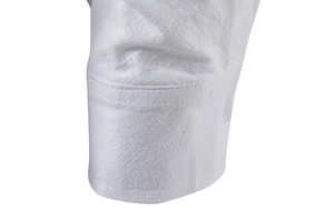 Macro shot of white linen shirt sleeve showing natural texture and fine stitching detail