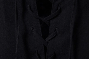 Detail van zwart katoen-linnen shirt met vetersluiting aan de V-hals en textuurstof