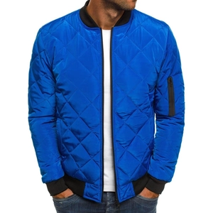 Detail of royal blue quilted bomber jacket showing ribbed cuffs and sleeve pocket