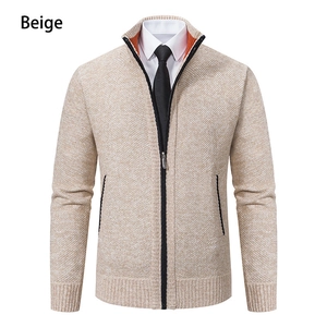 Detail of beige knit cardigan featuring a stand-up collar with orange lining and zip pocket