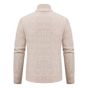 Detail of light beige knitted cardigan showing rib-knit texture on cuffs and hem