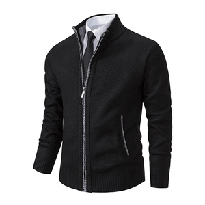 Detail of black knit cardigan featuring a stand collar and metal zipper closure