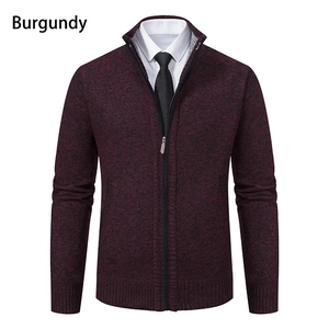Macro detail of burgundy knit cardigan featuring a stand collar and ribbed texture