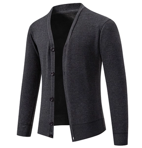 Detail of V-neck cardigan featuring five circular buttons and ribbed hem texture