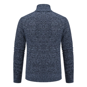Back view of thick knit cardigan showing navy blue textured waffle pattern and ribbed hem