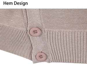 Detailed macro view of the ribbed hem design and brown buttons on this knit cardigan