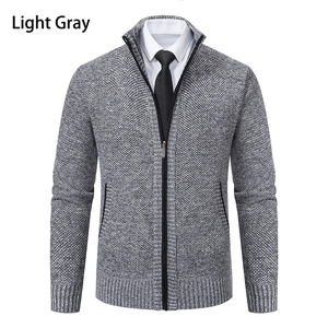 Macro shot of light gray men's knit cardigan with textured fabric and zipper detail