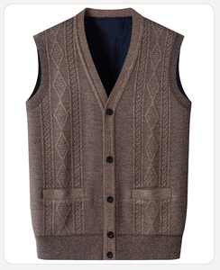 Detail of V-neck knitted cardigan vest with argyle pattern and button-up front in brown