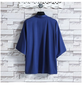 Rear view of a loose-fit dark blue ice silk kimono cardigan hanging on a brick wall